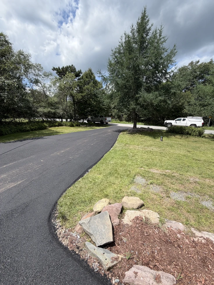 Freshly paved asphalt driveway after completion by Coopers Asphalt LLC